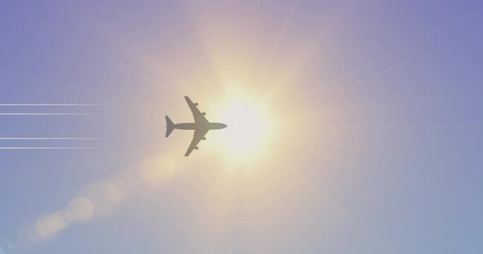 Plane in the sky. Jet aircraft flies across a blue sky in front of the bright sun.