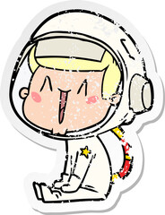 distressed sticker of a happy cartoon astronaut sitting