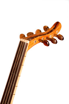 The image shows a closeup of the headstock and tuning pegs of an oud, a traditional Middle Eastern string instrument. The intricate details of the wood grain and the craftsmanship are visible.