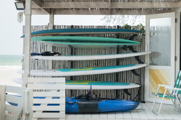 Sea surfboards shop at tropical beach.