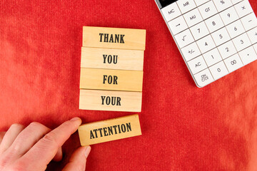 Thank you for your attention concept. Wooden blocks. Beautiful red background. The businessman's...