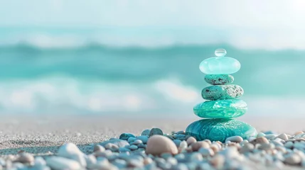 Sea glass Zen stones arranged in a balance pyramid on the beach. Beautiful azure color sea with blurred seascape background © standret