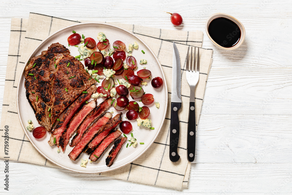 Wall mural fried beef steak with salad of grape, cheese