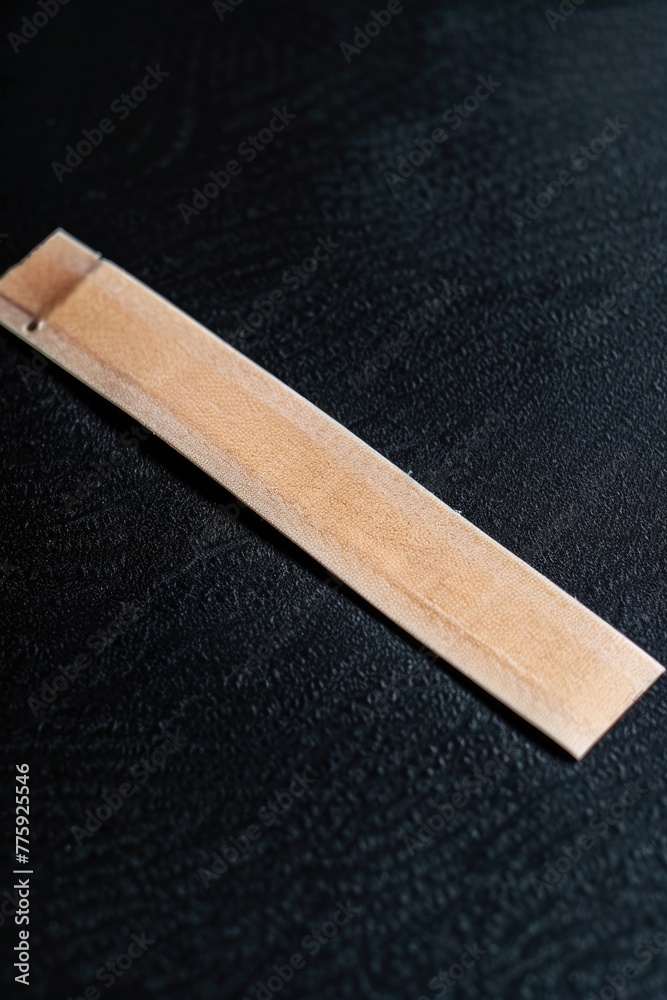 Poster a piece of wood on a black surface, versatile image for various design projects