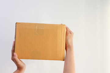 Young woman holding Cardboard box on white background.