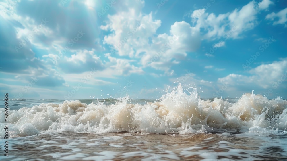 Poster a wave rolls in on the beach as the sun shines through the clouds. suitable for travel and nature co