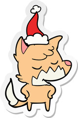 friendly hand drawn sticker cartoon of a fox wearing santa hat