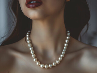Beauty wearing a white pearl necklace , fine jewelry concept 