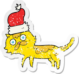 retro distressed sticker of a cartoon cat wearing christmas hat
