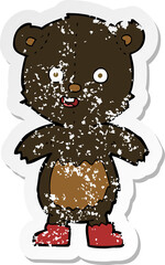 retro distressed sticker of a cartoon happy teddy bear in boots