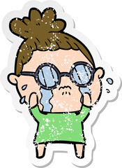 distressed sticker of a cartoon crying woman wearing spectacles