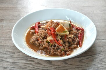 spicy chop pork Thai chili pasted topping salty egg on plate 