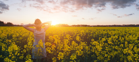 allergy, woman enjoying summer flowers and nature in the field at sunset, freedom, harmony and healthy lifestyle, banner background with copyspace - 775955911
