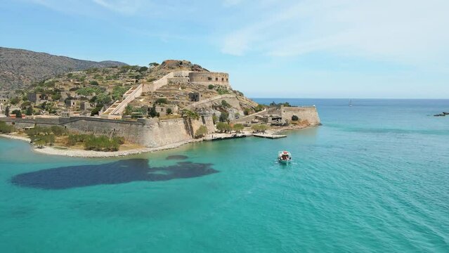View of the fortress on the Spinalonga island with calm sea. Old venetian fortress and former leper colony.