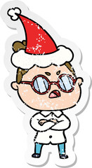 hand drawn distressed sticker cartoon of a annoyed woman wearing santa hat