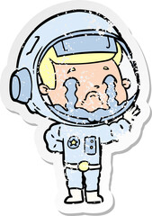 distressed sticker of a cartoon crying astronaut