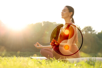 Beautiful woman meditating on green meadow in morning. Yin and yang symbol