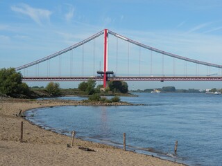 Scenic view of the coast of an ocean with a bridge over it