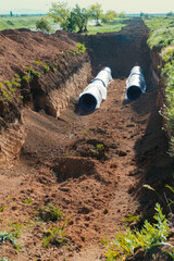 Laying a water pipe (water conduit) underground. Two large diameter pipes
