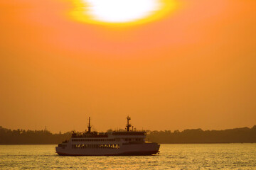 Pleasure boat off the coast of the Andaman Sea. Thailand. Tropical sunset over the coast. Wintertime sun