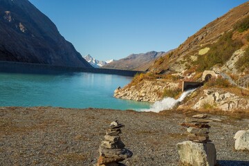 Lake surrounded by snow-capped mountains in the alps of Switzerland