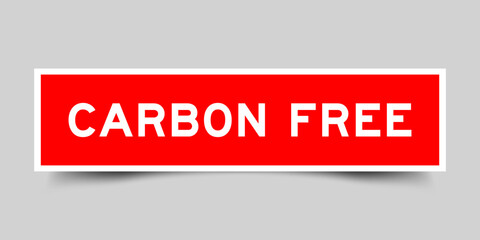 Red color square shape sticker label with word carbon free on gray background