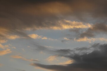 Yellow and gray sunset cloudscape in the bue sky