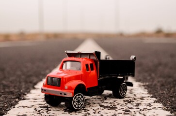 Closeup of a truck miniature on an asphalt road