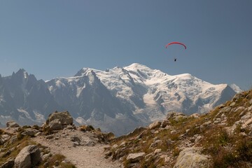 View of a person paragliding over the Mont Blanc mountain peak in Europe