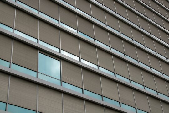 Low-angle shot of office building windows in a symmetric and organized way - great for backgrounds