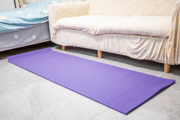 A yoga mat on the living room floor