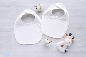 Two white blank baby bibs, mockup for design presentation, flat lay composition,