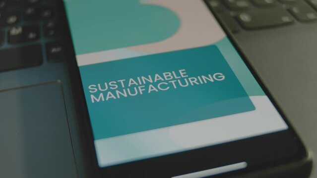 Sustainable Manufacturing inscription on smartphone screen. Graphic presentation with moving colored shapes on background. Manufacturing concept
