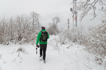 Man in a hiking outfit in the snowy woods