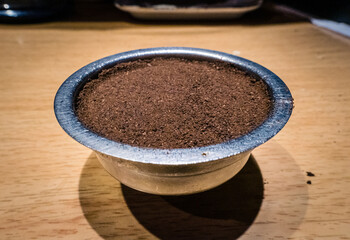 Closeup of freshly ground coffee on a wooden table