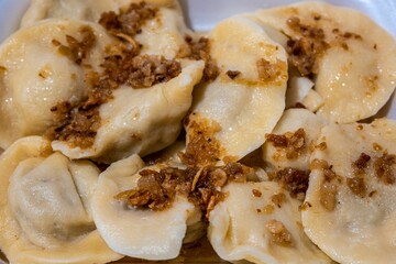 Closeup of newly baked pierogies in a white plate