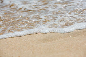 Wavelets washing up on the sunny beach