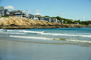 Beautiful scenery of York Beach in the gulf of Maine next to houses on a coastline