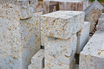 Travertine stone slabs and blocks ready to be mounted in a construction site
