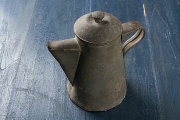 Closeup shot of an ancient teapot made of tin or metal