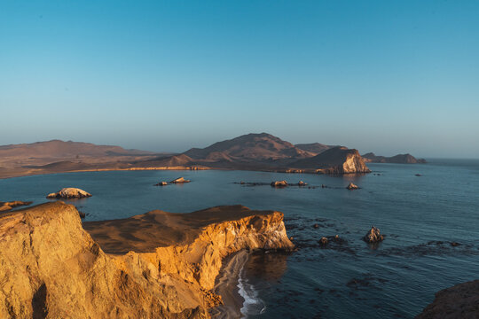 sunset over the sea at the coast of Paracas Peru