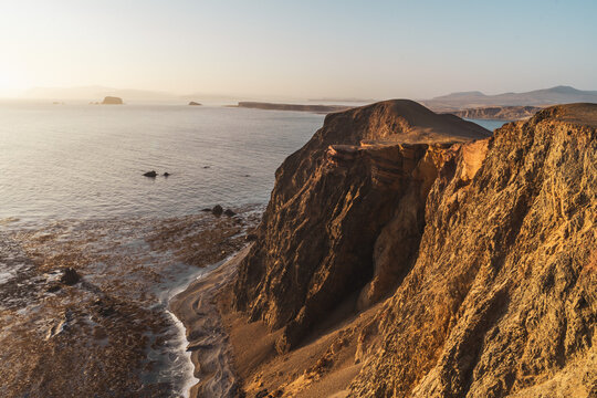 sunset over the sea at the coast of Paracas Peru