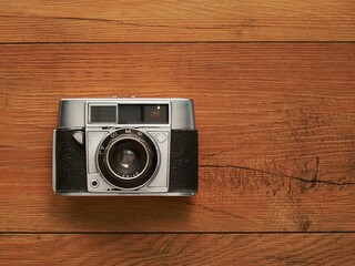 Old camera in wooden background