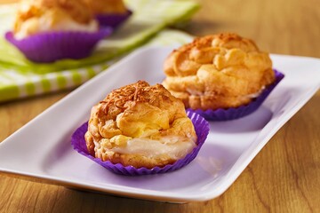 Close-up shot of Indonesian choux cakes on a white plate on a wooden table