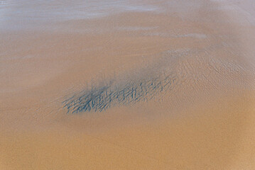 Closeup shot of Rio Vermelho beach sand in Salvador, Bahia, Brazil