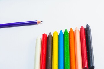 Colored wax and wooden pencils isolated on a white background