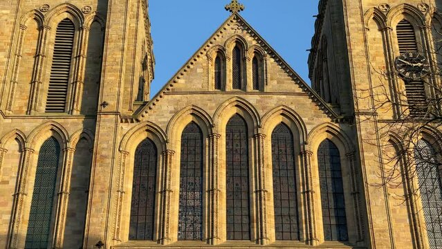 Tilt down of front facade of Ripon Cathedral, Ripon, Yorkshire, England