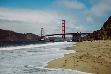 Distant shot of the Golden Gate Bridge over water in Baker Beach, San Francisco