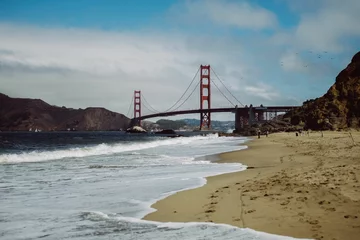 Fotobehang Baker Beach, San Francisco Distant shot of the Golden Gate Bridge over water in Baker Beach, San Francisco