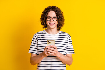 Photo portrait of handsome teenager guy hold device chatting friend dressed stylish striped garment...